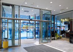Automatic sliding door drive Slimdrive SL with integrated all-glass system at Krämaren shopping centre in Örebro, Sweden