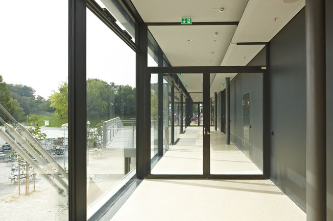 Felső szerelésű, csúszósínes ajtózár TS 5000 R-ISM, beépítve a müncheni Coubertinben. Tűzszakaszajtó TS 5000 R-ISM-mel, csúszósínes ajtócsukó rendszer kétszárnyú ajtókhoz csukássorrend szabályozással és füstkapcsolóval.