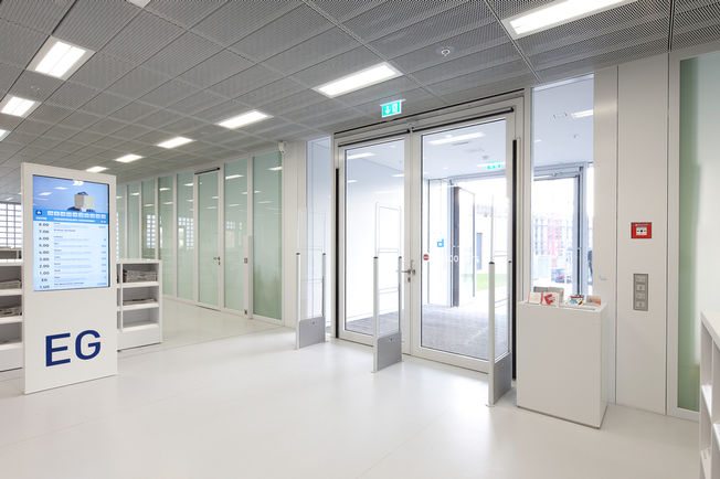 Forhallen til hovedindgangen med 2-fløjede Slimdrive EMD F-IS svingdørssystemer i brandsikkert design. Foto: Lazaros Filoglou for GEZE GmbH