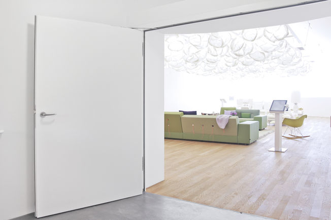 Door closer Boxer ISM in the Vitra House Integrated door closer system for double leaf doors with closing sequence control, electric hold-open device and integrated back check that slows down strongly opened doors.
