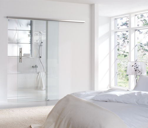 Levolan 60 sliding door system, installed in a residential building Sliding fitting for glass leaves weighing 60 kg and with one or damped on both sides for doors, so that the door is gently slowed down and independently dragged into the end position