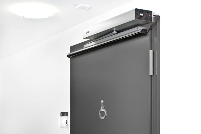 Swing door drive - Slimdrive EMD-F, VGH Versicherungen (insurance company) Hanover Electromechanical swing door system for double leaf fire and smoke protection doors with integrated mechanical closing sequence control and integrated smoke switch