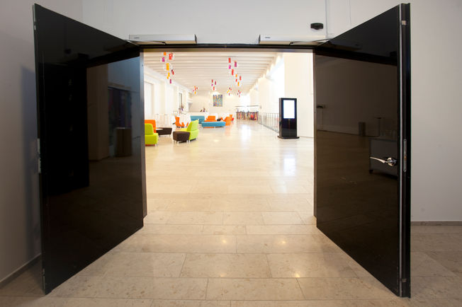 Swing door drive - Slimdrive EMD F-IS, Tivoli congress centre Copenhagen Electromechanical swing door system for double leaf fire and smoke protection doors with integrated mechanical closing sequence control