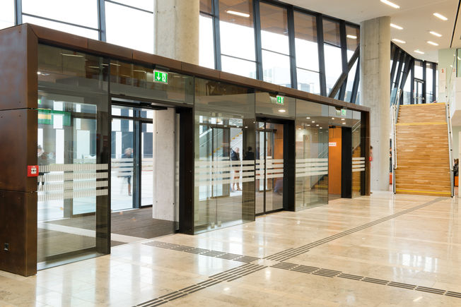 Automatic sliding door Slimdrive SL-FR at the Vienna University of Economics Specially designed for installation in emergency exits, the sliding door system finds GEZE Slimdrive SL-FR application when safety is a priority.