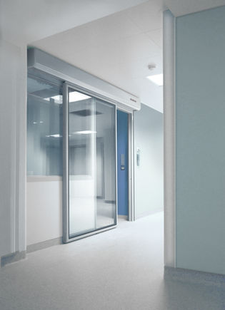 Drive block solution GEZE Powerdrive PL-HT, installed in a hospital door Automatic linear sliding door system for large heavy doors in areas with increased hygiene demands