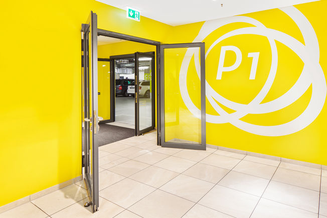 Glazed security interlocking door to the Milaneo parking level, opened.