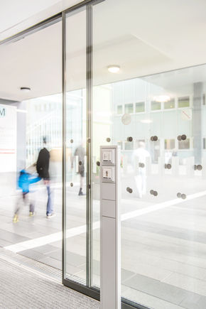 Design element: door programming switch in a metal stele on the automatic sliding door in the foyer.