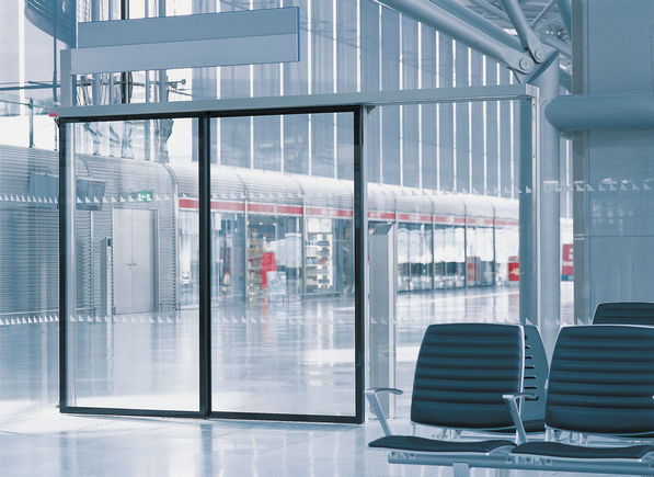 Automatic sliding door drive Slimdrive SLT at Cologne-Bonn airport Automatic telescopic sliding door system for use in narrowest glass façades with two parallel surface mounted tracks, the door leaves lead and achieve high opening widths.