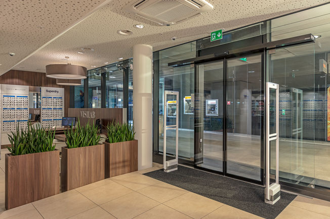 Installation of the automatic sliding door drive Slimdrive SL NT-FR at the railway station of Zurich Oerlikon Automatic linear sliding door system for emergency exits with low height and clear design line