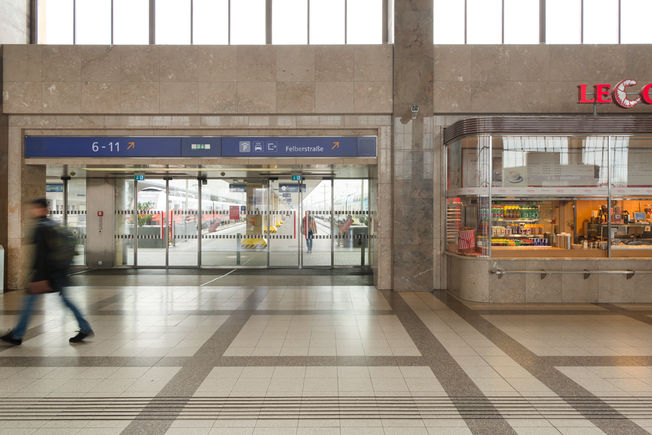 Installation of the automatic sliding door drive Slimdrive SL-FR Vienna Westbahnhof Automatic linear sliding door system with low height and clear design line