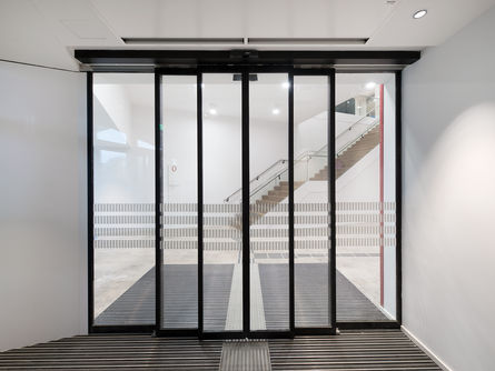 Slimdrive SLT-FR automatic sliding door drive, installed at Vienna University of Economics Automatic telescopic sliding door system for escape and rescue routes for use in narrow glass façades