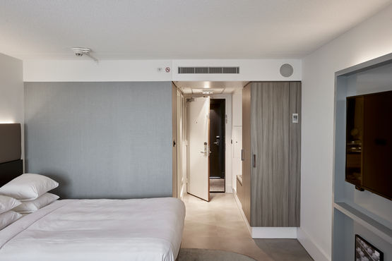 Hotel room with open room door.