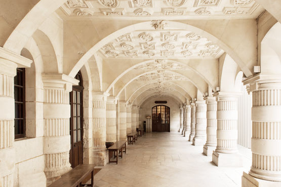The historic arcade walkway leads to the modern entrance door.