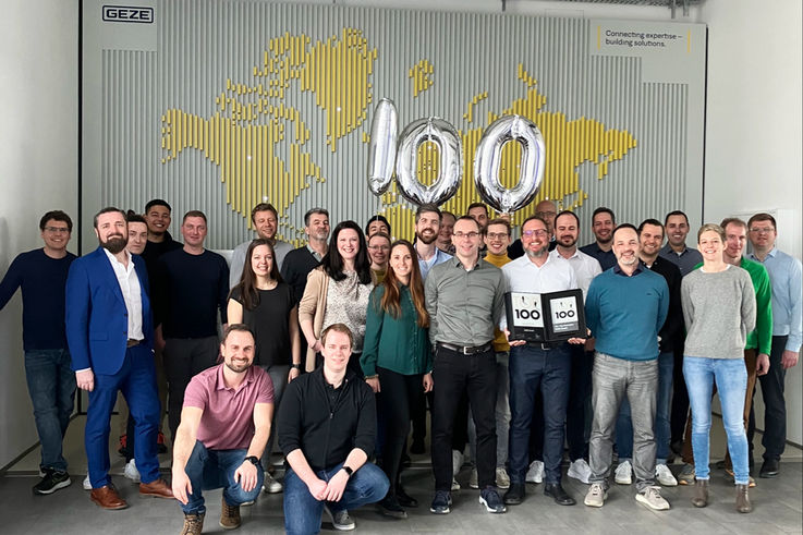 GEZE employees proudly present the Top 100 Award