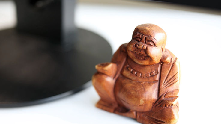 View of a Buddha standing on the desk