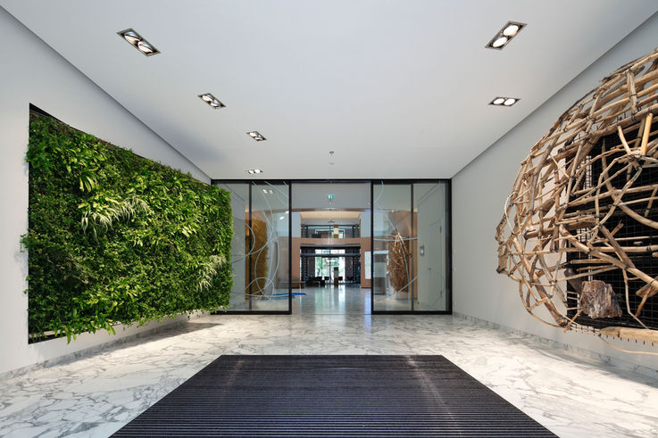  - The centre of the open, circular foyer is a transparent vestibule dominated by fine-framed automatic thermal insulation glass linear sliding doors with GEZE Slimdrive SL NT 