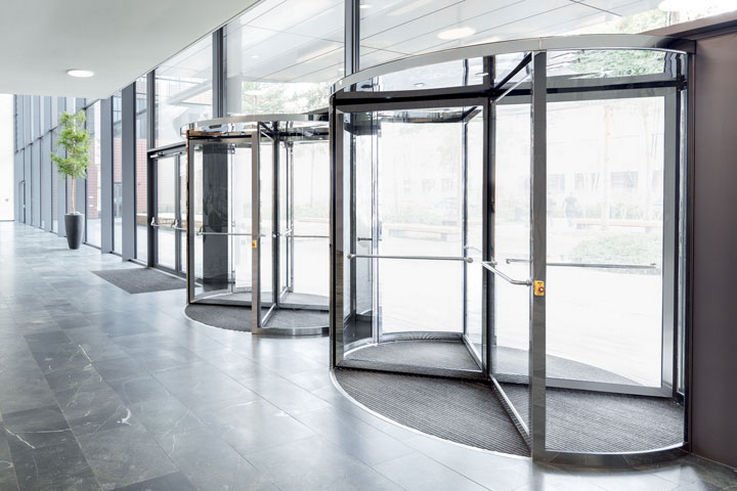 Revolving doors - Revolving doors fulfil multiple purposes at entrances of public buildings. Safe, convenient and in an elegant design, they enable people to come in and go out without disruption.